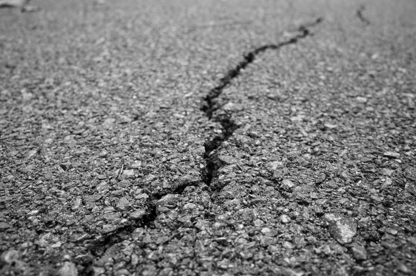 Gray rough asphalt with thick crack