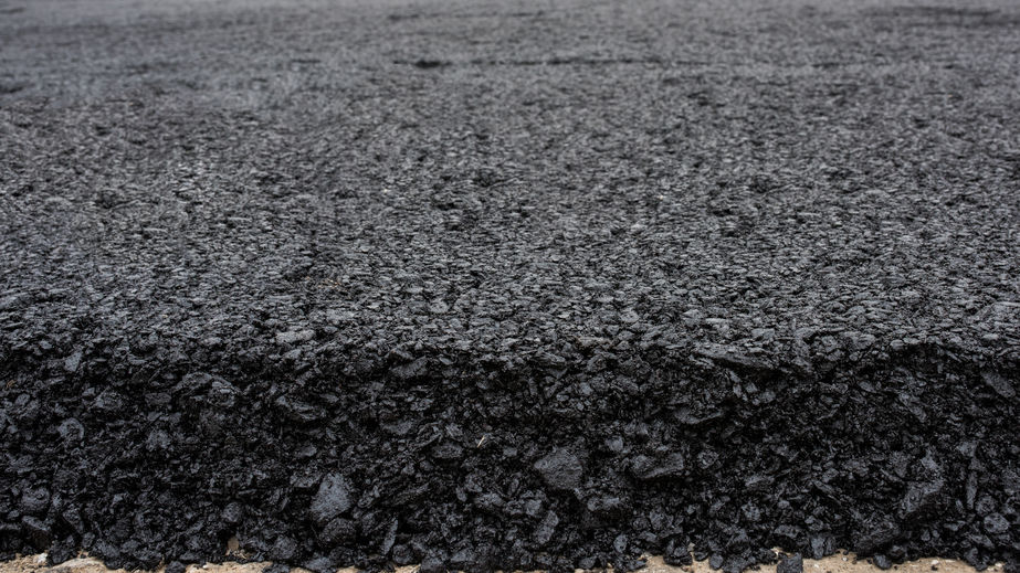 In flexible pavements, the upper layer consists of asphalt concrete, that is a construction aggregate with a bituminous binder. The wearing course is typically placed on the base course